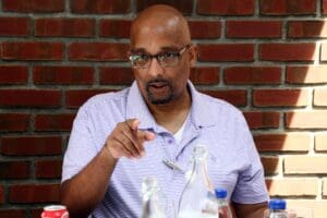 A man with glasses is sitting at a table