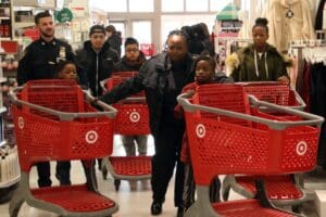 A group of people in a store with shopping carts.