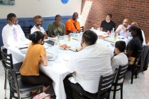 A group of people sitting around a table.