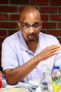 A man with glasses is sitting at a table