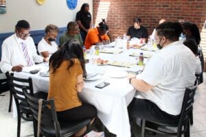 A group of people sitting around a table.