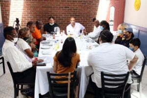 A group of people sitting around a table.