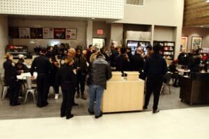 A crowd of people standing around in an area.