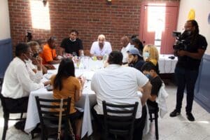 A group of people sitting around a table.