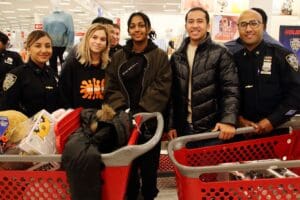 A group of people standing around shopping carts.