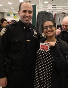 A police officer and a woman posing for the camera.