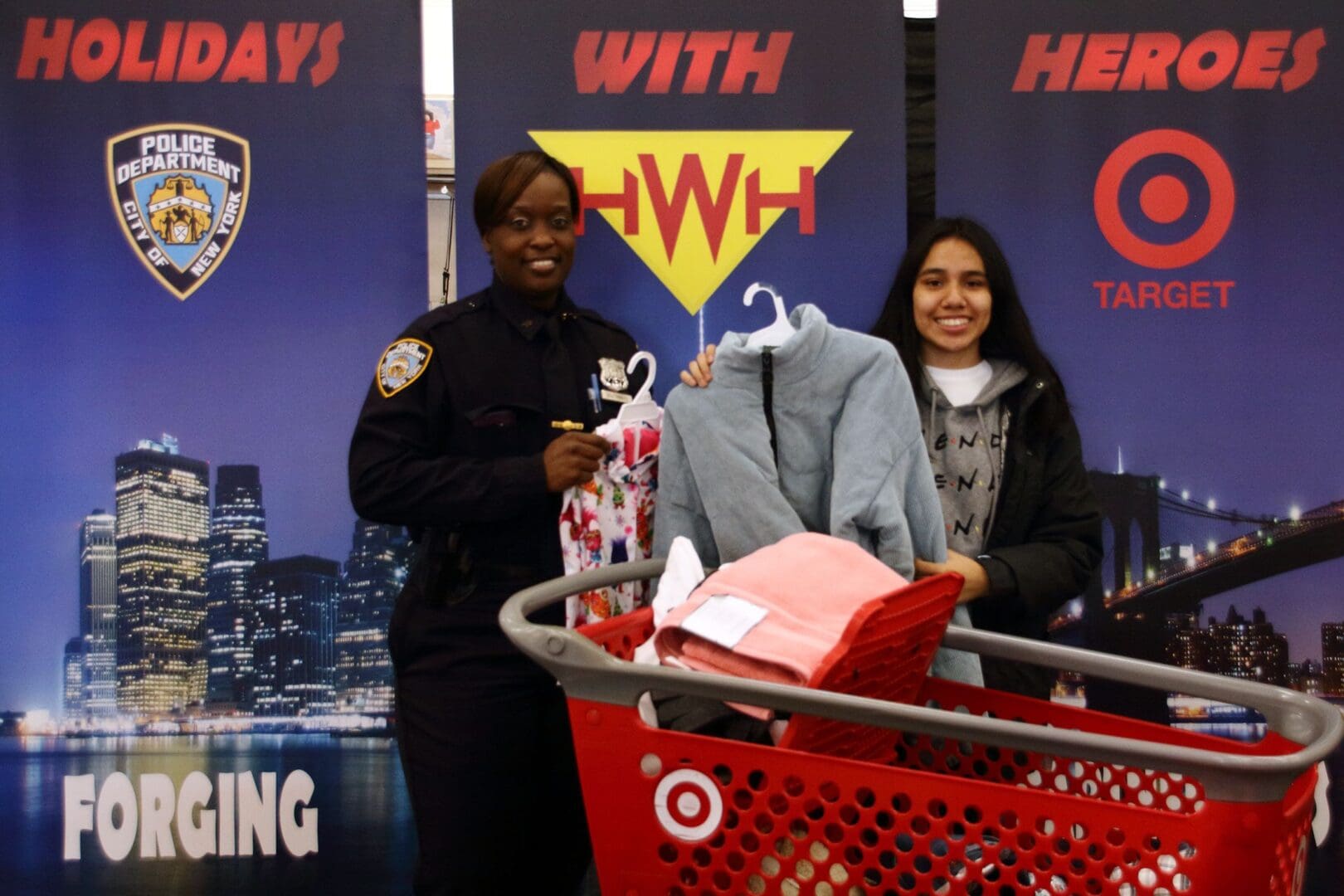 A woman standing next to a man holding onto some clothes