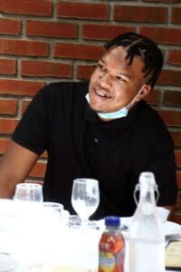 A man sitting at the table with wine glasses.