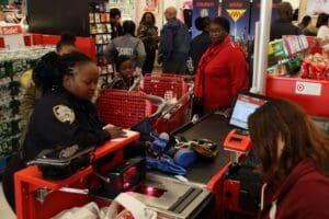 A woman is sitting at the checkout counter of a store.