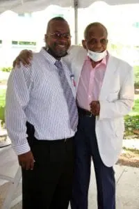 Two men in suits and ties posing for a picture.