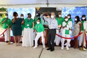 A group of people standing around in front of an event.