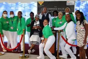 A group of people in green and white outfits.