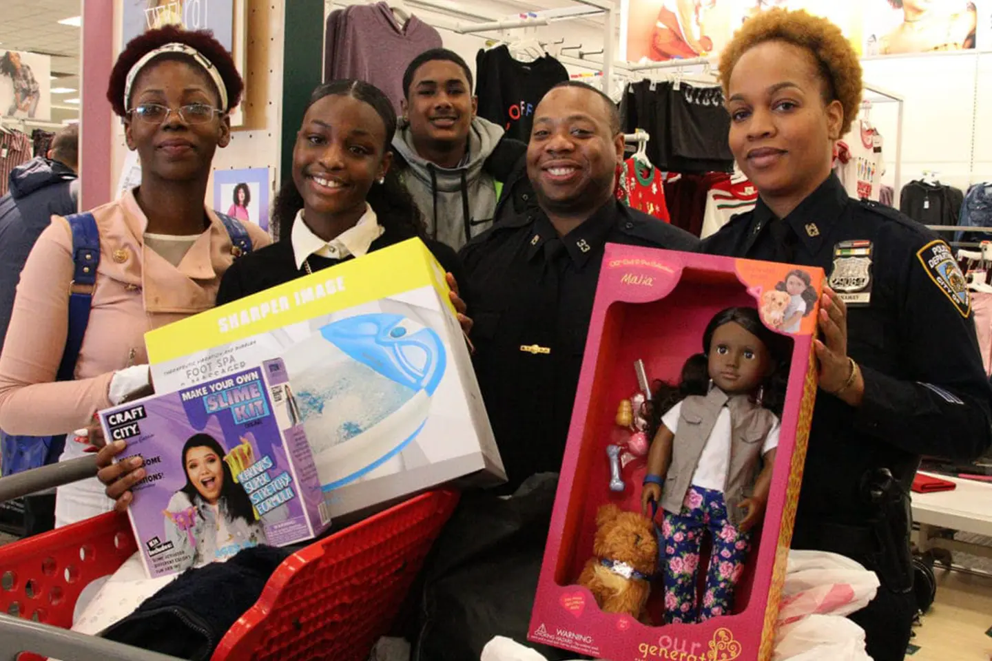 A group of people holding boxes and dolls.