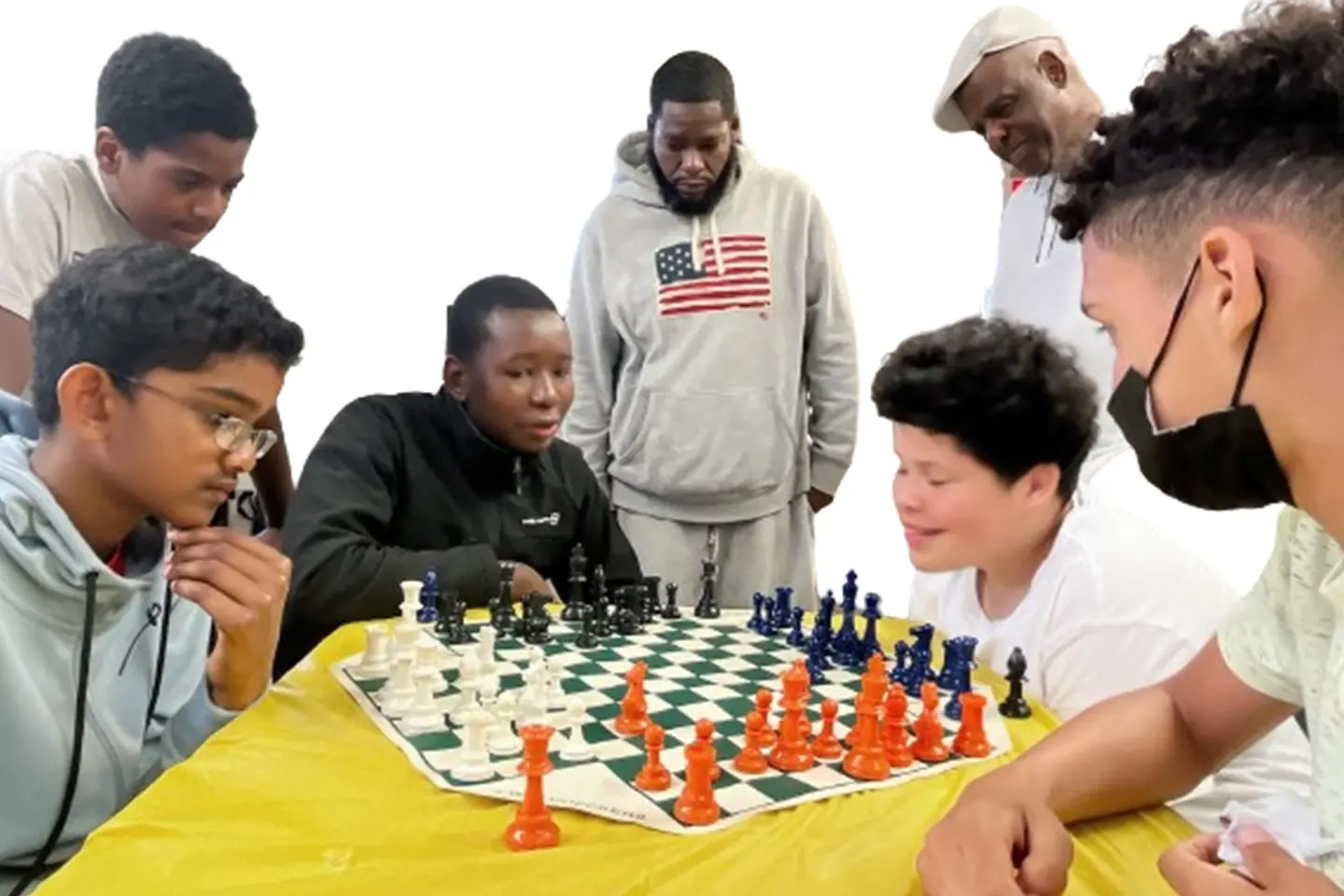 A group of people playing chess on a table.